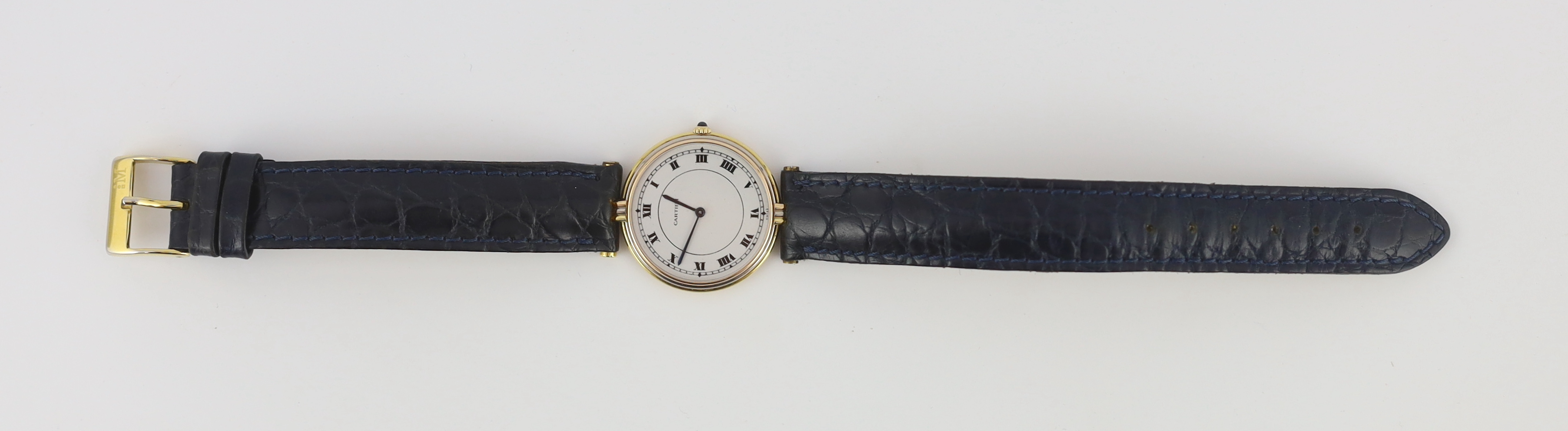 A lady's modern Cartier 18k gold quartz wrist watch, on associated leather strap and buckle